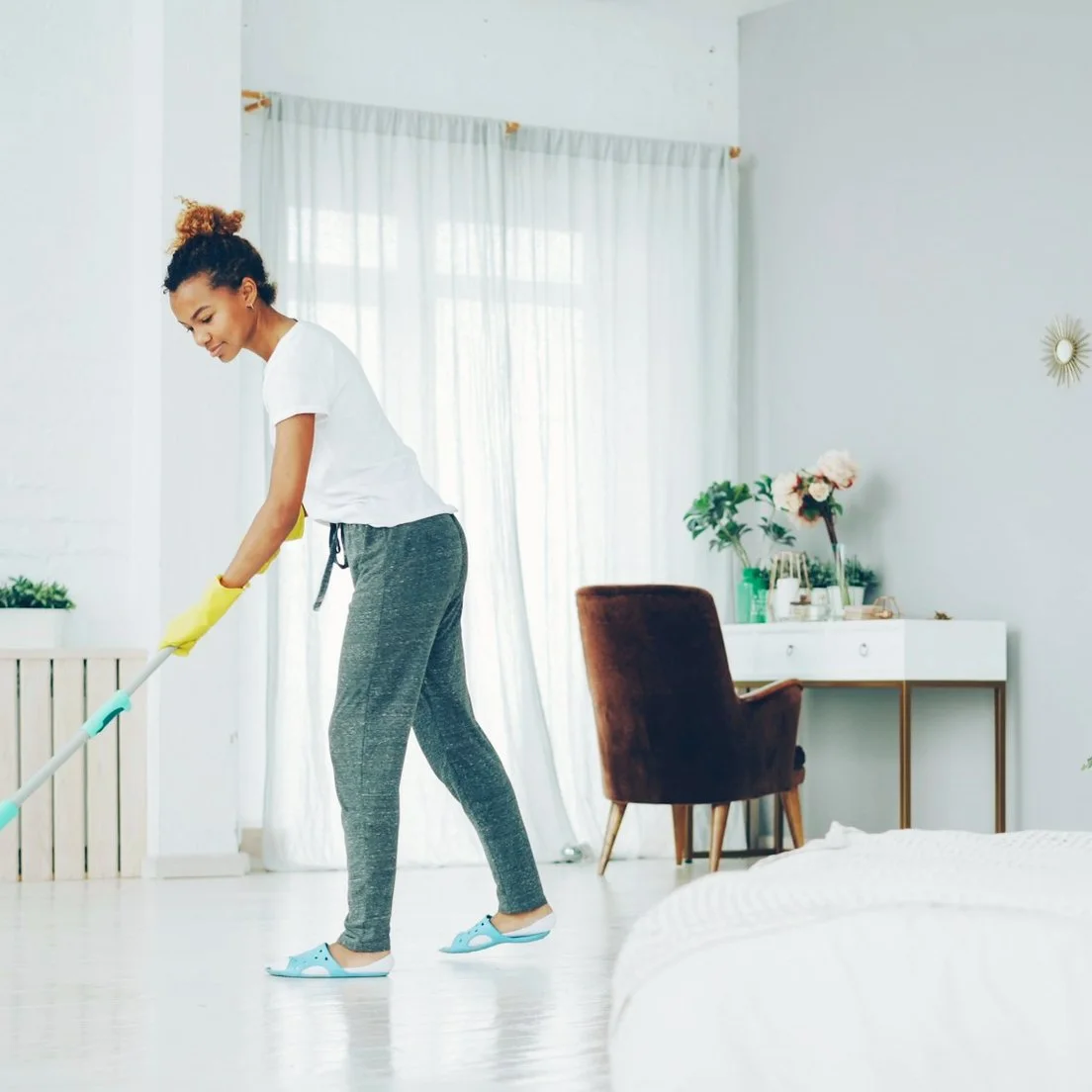 A RESET member cleaning a bright room