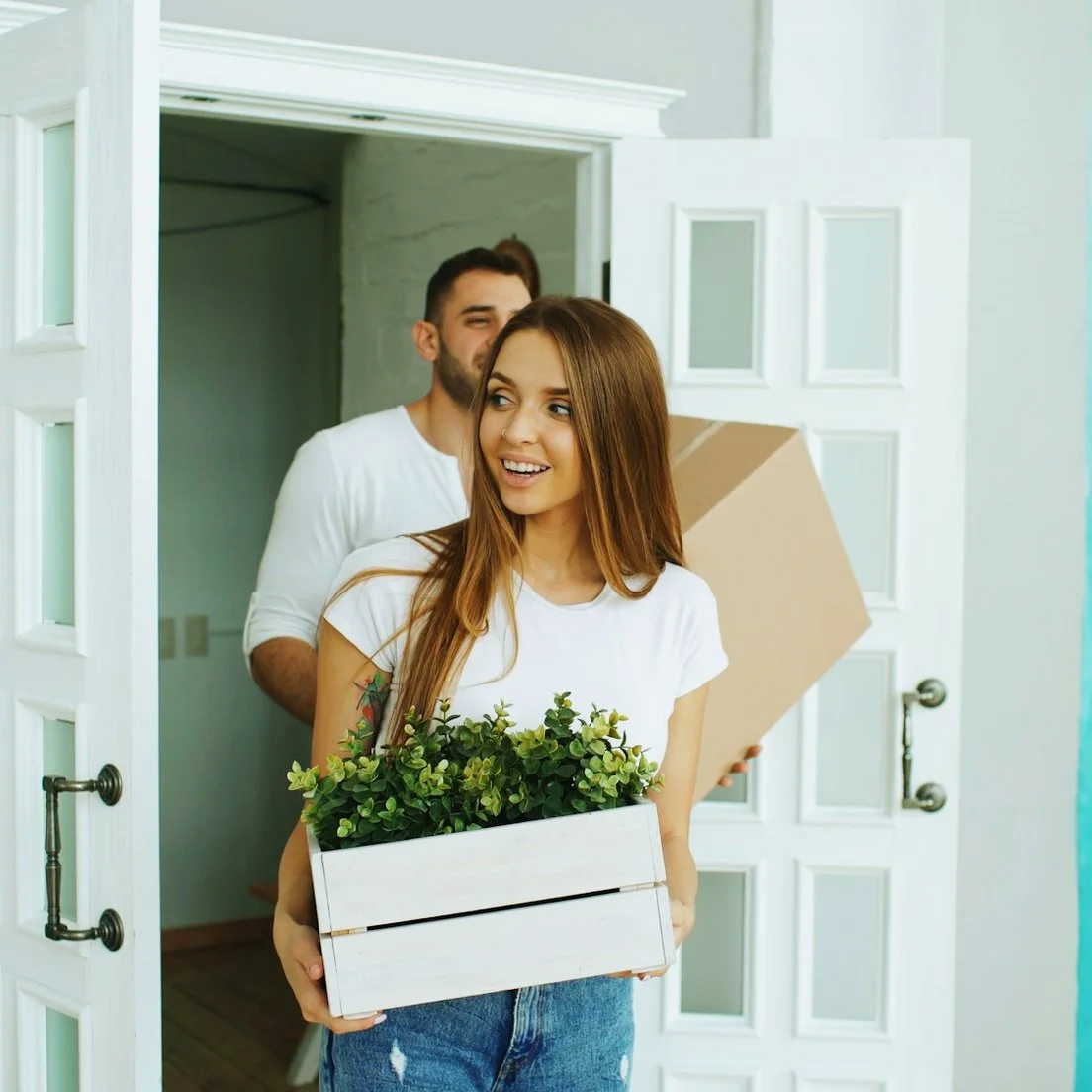 A couple moving in with a box